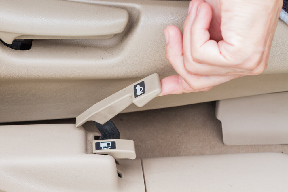 A Hand Releasing The Interior Trunk Release Button