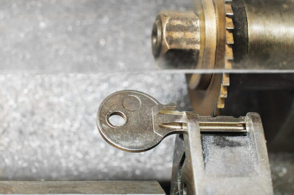A key getting duplicated through a key duplicator machine