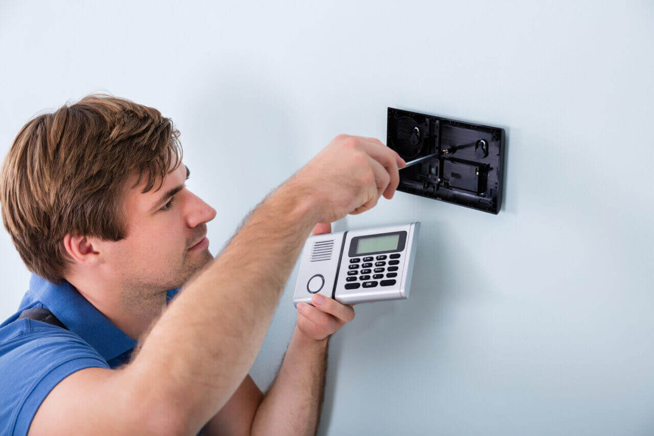 A locksmith installing a smart door lock