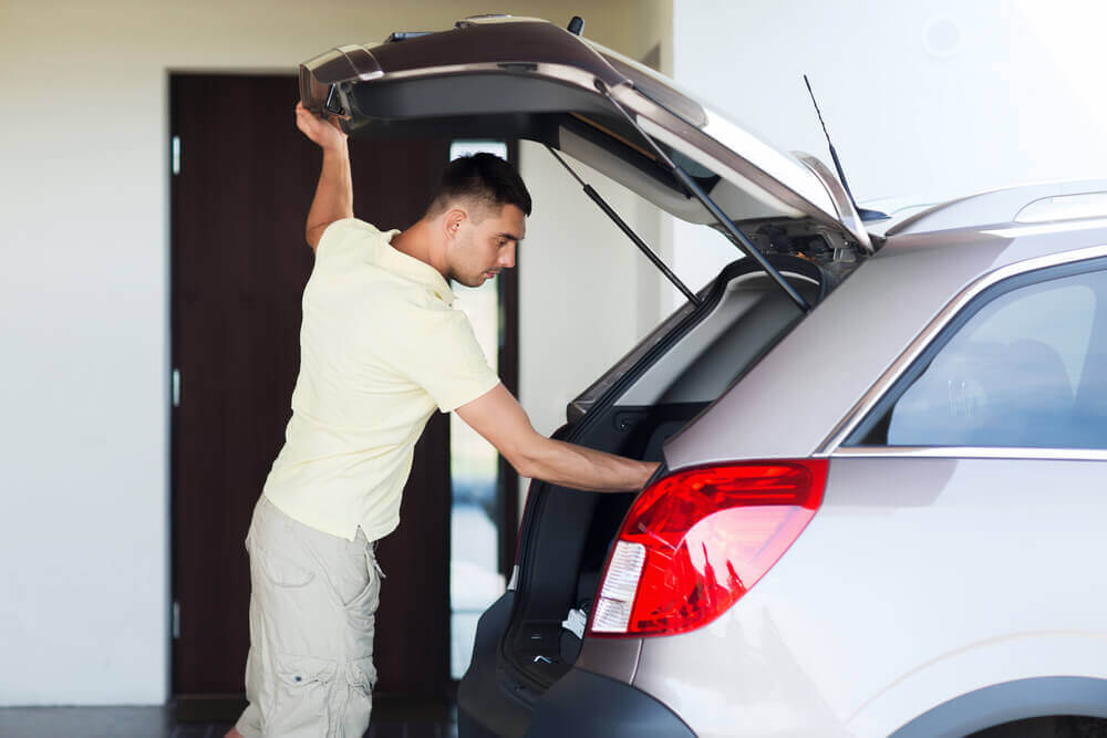 A Person Opening The Car Trunk