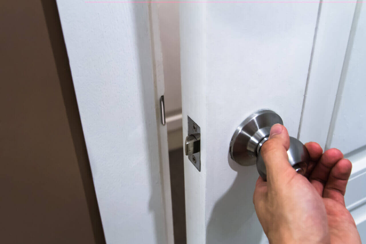 Close up of a hand closing a door