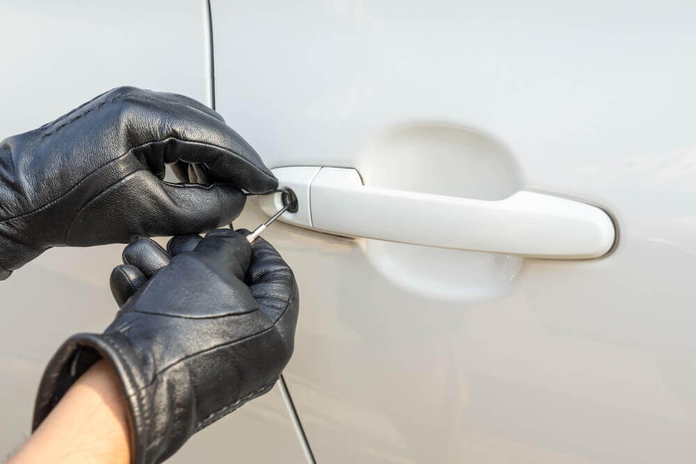 A Locksmith Inserting A Tool Into A Car Door Lock