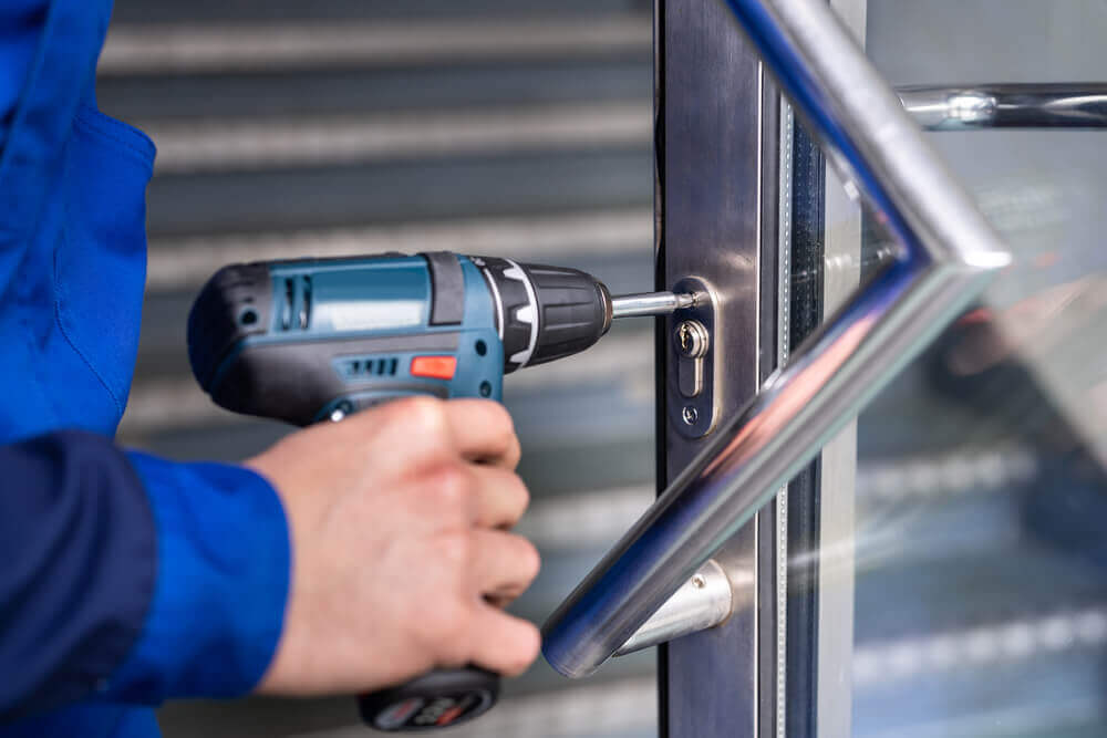 A Locksmith Installing A New Lock