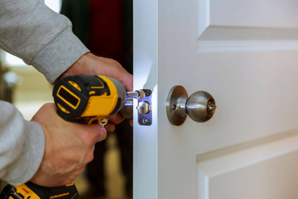 A Locksmith Working On The Door Lock