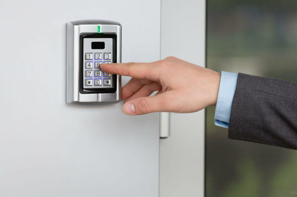 a person inputting code on an electronic combination lock