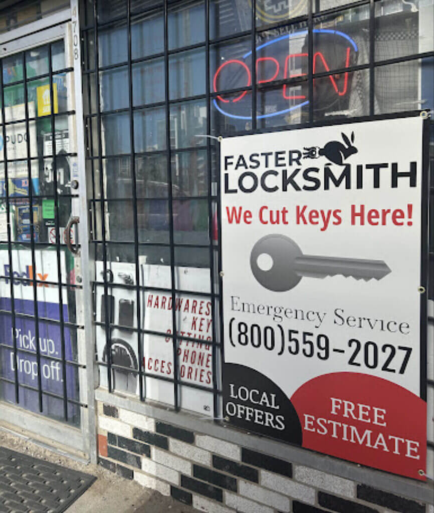 A locksmith shop entry with bars on the door. Signs display "OPEN" and "Faster Locksmith - We Cut Keys Here!" including contact details (800-559-2027). Another sign reads "Hardware and Key Accessories," and there's a poster for "Pick up. Drop off." The shop is your one-stop locksmith solution.